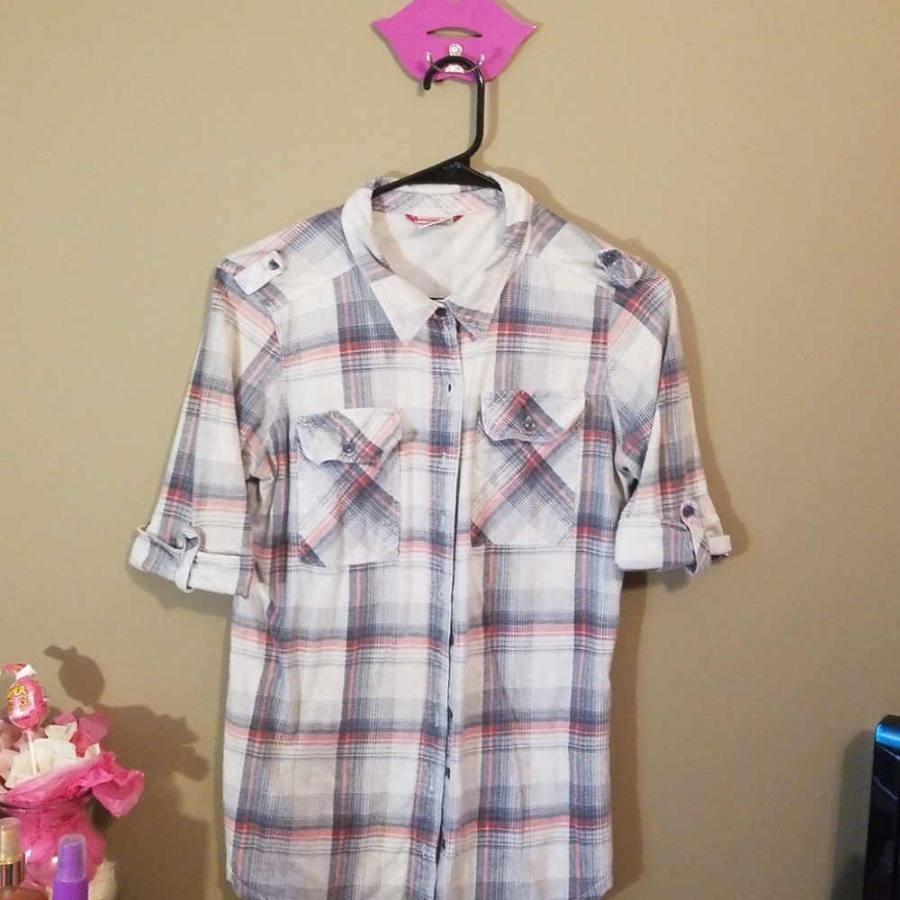 It is a plaid shirt with buttons with a few colors